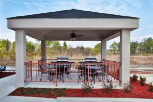 a gazebo with tables and chairs on it at Candlewood Suites Slidell Northshore, an IHG Hotel in Slidell