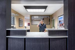 a man talking on a cell phone in a hospital lobby at Candlewood Suites Sterling by IHG in Sterling