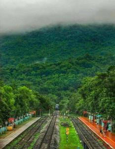 a train on the tracks at a train station at Sterling Karwar in Kārwār