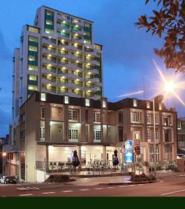 a large building with tables and chairs in front of it at Astor Metropole Hotel in Brisbane