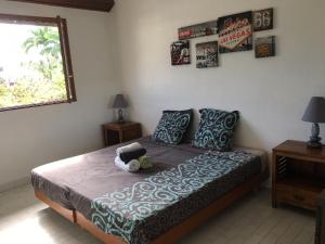 a bedroom with a bed with a stuffed animal on it at CASE BEAOEL in Saint-Gilles les Bains