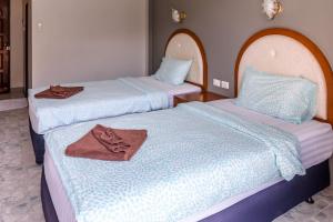 A bed or beds in a room at Pineapple Guesthouse