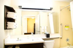 a bathroom with a sink and a large mirror at Candlewood Suites York, an IHG Hotel in York