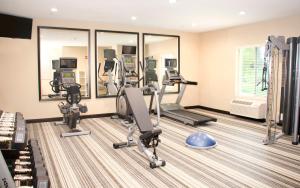 a gym with treadmills and ellipticals in a building at Candlewood Suites York, an IHG Hotel in York