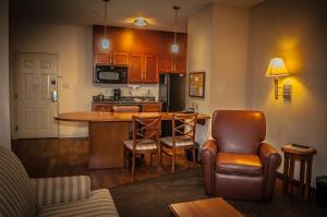 a living room with a kitchen with a table and chairs at Candlewood Suites New Iberia, an IHG Hotel in New Iberia