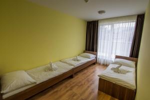 Postel nebo postele na pokoji v ubytování Hotel Aréna
