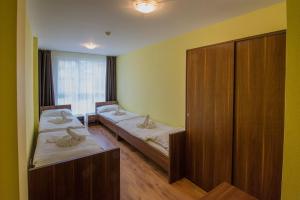 Postel nebo postele na pokoji v ubytování Hotel Aréna