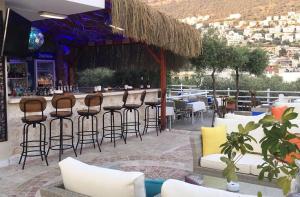 a bar at a restaurant with chairs and tables at Oasis Hotel in Kalkan