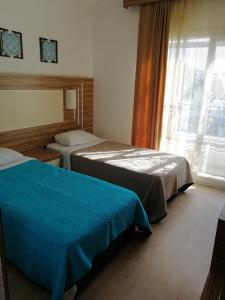 Postel nebo postele na pokoji v ubytování Serhan Hotel