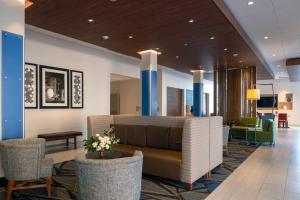 a lobby of a hotel with a couch and chairs at Holiday Inn Express & Suites - Tulsa Downtown - Arts District, an IHG Hotel in Tulsa