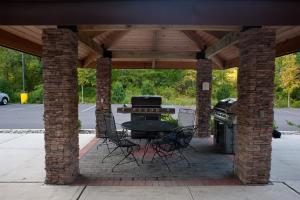 a pavilion with a table and chairs and a grill at Staybridge Suites East Stroudsburg - Poconos by IHG in East Stroudsburg