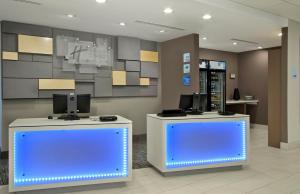 a lobby with two counters with computers on them at Holiday Inn Express & Suites Columbus North, an IHG Hotel in Columbus