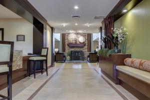 a corridor with a lobby with a fireplace at Staybridge Suites St Louis - Westport, an IHG hotel in Maryland Heights