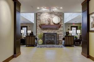 a lobby with a stone fireplace in a room at Staybridge Suites St Louis - Westport, an IHG hotel in Maryland Heights