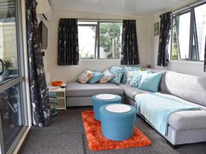 a living room with a couch and a table at Hector's Tiny House - Akaroa Holiday Home in Akaroa