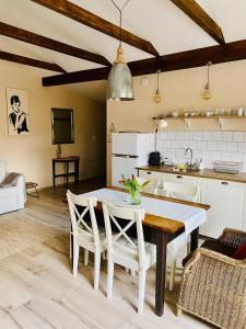 a kitchen and dining room with a table and chairs at LizMari in Podčetrtek