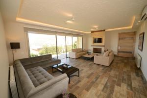 a large living room with a couch and a table at Mist Hotel & Spa in Ehden