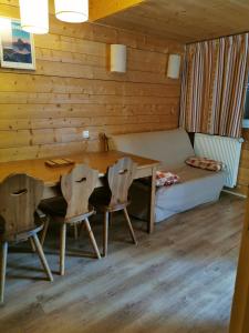 a room with a table and chairs and a bed at Appartement Cauterets in Cauterets