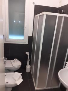 a bathroom with a toilet and a sink at Residence Villa Gori in Rimini