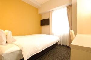 Postel nebo postele na pokoji v ubytování AB Hotel Fuji
