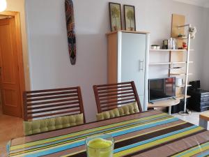 a room with a table and two chairs and a television at Solmar II Solo Familias Serviplaya in Playa de Xeraco