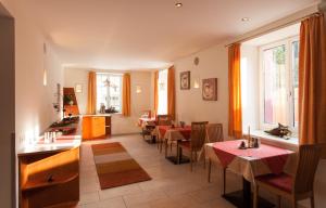 a restaurant with tables and chairs in a room at Pension Edelweiss in Gargellen