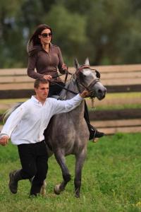 a man and a woman riding a horse at Apartments Ivica i Marica in Karanac