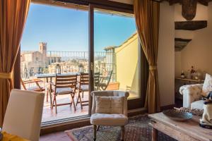 a living room with a view of a balcony at La Terrazza sul Duomo in Siena