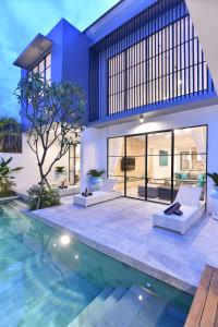 a house with a pool in front of it at Villa Verde close to Finns Beach Club in Canggu