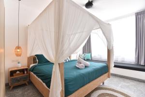 a bedroom with a bed with a canopy at Villa Verde close to Finns Beach Club in Canggu