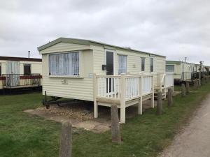 a row of mobile homes parked in a field at 6 Berth Golden Sands Ingoldmells Sahara in Ingoldmells