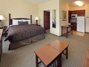 a hotel room with a bed and a kitchen at Staybridge Suites Hot Springs, an IHG Hotel in Hot Springs