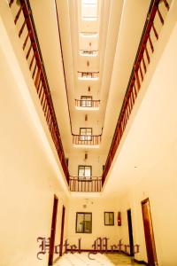 una habitación vacía con escaleras y mesas en un edificio en Metro Hotel, en Nairobi