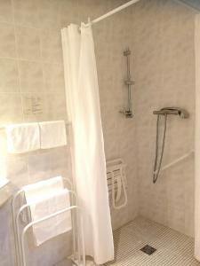 a bathroom with a shower with a white shower curtain at HOTEL DU MIDI in Beaufort-sur-Gervanne
