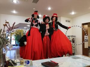 three women dressed up in dresses posing for a picture at Hotel Belvedere in Venice-Lido