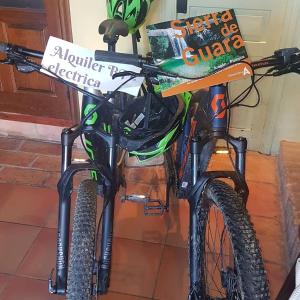 a bike is parked next to a book at Mesón de Colungo in Colungo