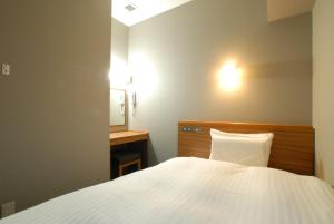 Postel nebo postele na pokoji v ubytování AB Hotel Fuji