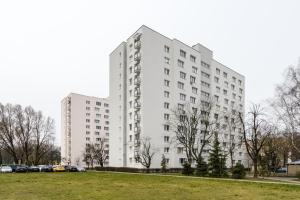 a white building with a park in front of it at Labo Apartment Niska by Old Town in Warsaw