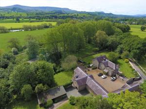 an aerial view of an old house in a field at Glanhenwye Courtyard Cottages in Glasbury