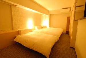 Postel nebo postele na pokoji v ubytování AB Hotel Fuji