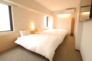 Postel nebo postele na pokoji v ubytování AB Hotel Fuji