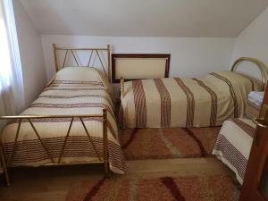 two twin beds sitting in a corner of a room at Casa Gotika in Vama