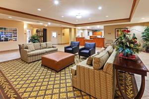 a lobby with couches and chairs and a table at Candlewood Suites Baytown, an IHG Hotel in Baytown