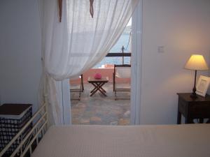 a bedroom with a bed and a view of the ocean at Calma in Perdika