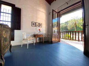 a room with a table and chairs and a sliding glass door at El Molino Estepona in Estepona