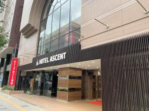 a modern apartment building on a city street at Hotel Ascent Hamamatsu in Hamamatsu