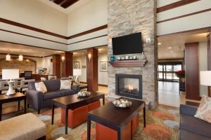 a living room with a fireplace and a tv at Staybridge Suites Midland, an IHG Hotel in Midland