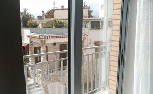 a window with a view of a city at Luxurious Studio, near Athens Airport in Markopoulo