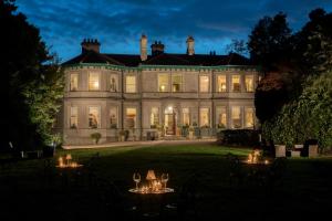 a large house with tables in front of it at Ardtara Country House in Upperlands