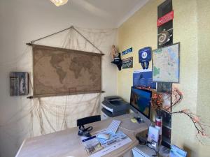 an office with a desk with a computer and a map at Lagos Marina Guest House in Lagos